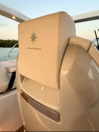  Yacht Photos Pics 2024 Jeanneau DB/43 OB boat seat with logo, featuring elegant beige upholstery.