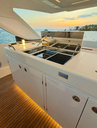  Yacht Photos Pics 2024 Jeanneau DB/43 OB yacht kitchen with sunset view, featuring sleek design and modern amenities.