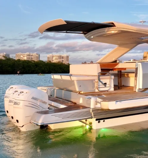 Yacht Photos Pics 2024 Jeanneau DB/43 OB yacht with outboard motors, docked on calm water at sunset.