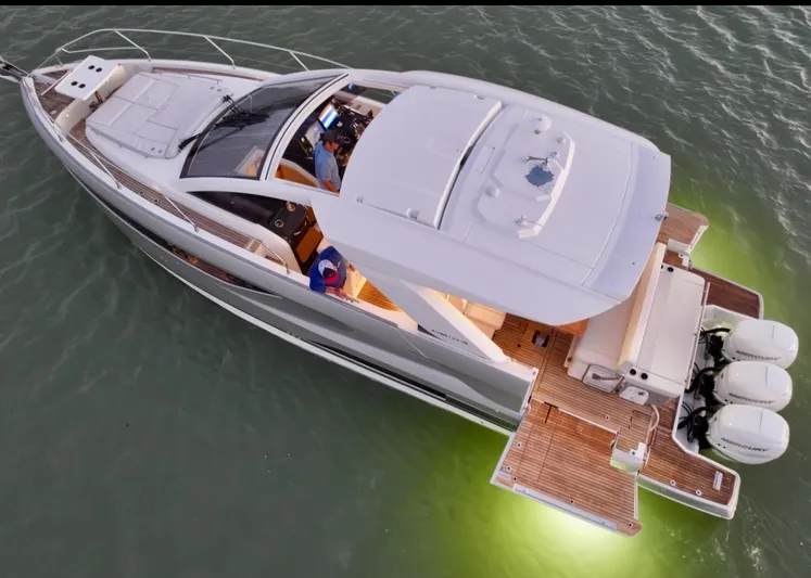  Yacht Photos Pics 2024 Jeanneau DB/43 OB luxury yacht with illuminated deck, cruising on water.