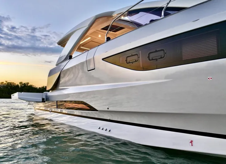  Yacht Photos Pics 2024 Jeanneau DB/43 OB yacht on water at sunset, showcasing sleek design.