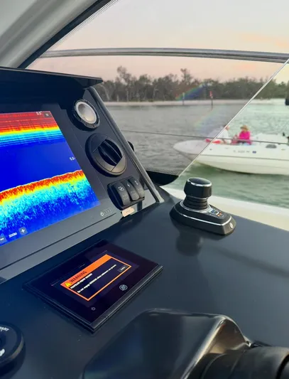  Yacht Photos Pics 2024 Jeanneau DB/43 OB dashboard with navigation display, joystick control, and scenic water view.