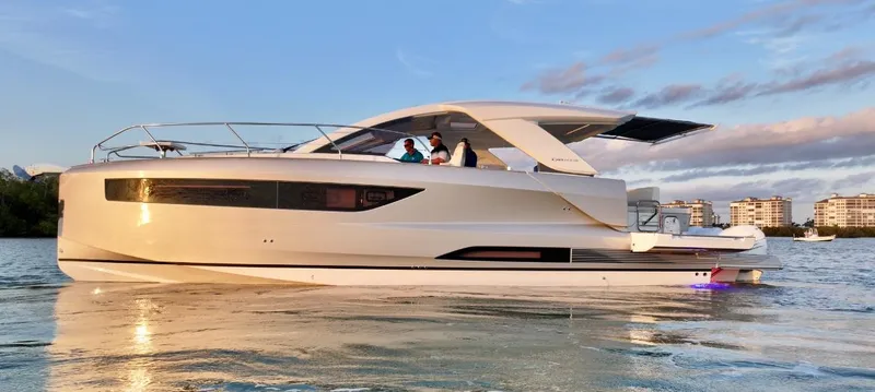  Yacht Photos Pics 2024 Jeanneau DB/43 OB yacht cruising on calm water at sunset.