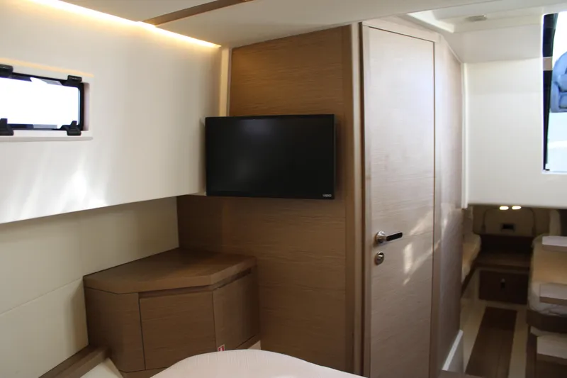  Yacht Photos Pics Luxurious interior of 2025 Pardo Yachts 38, featuring modern wood finishes and a mounted TV.