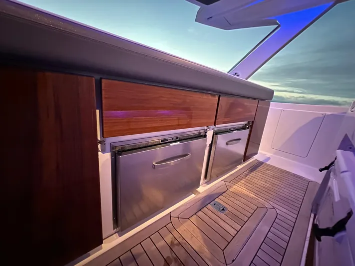  Yacht Photos Pics 2020 Tiara Yachts 43 LS interior with wooden cabinetry and stainless steel appliances.