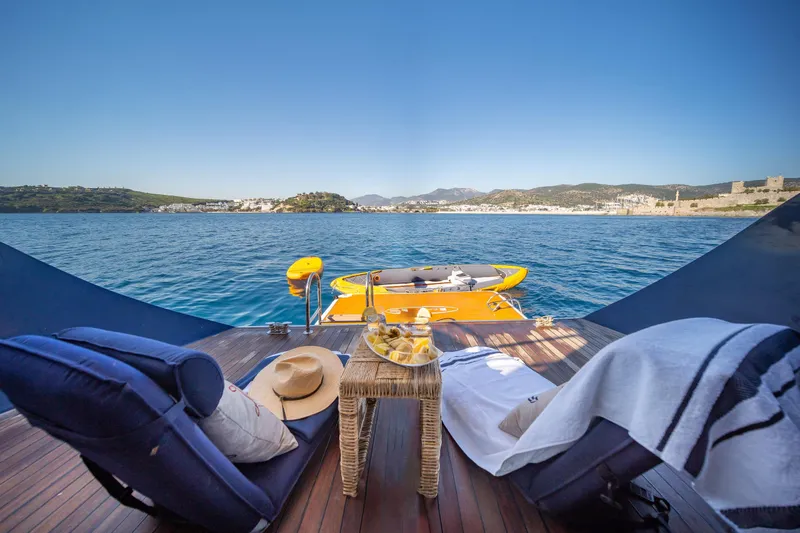  Yacht Photos Pics Luxurious deck view from 2023 Custom Made Motorsailer, featuring lounge chairs and scenic ocean backdrop.
