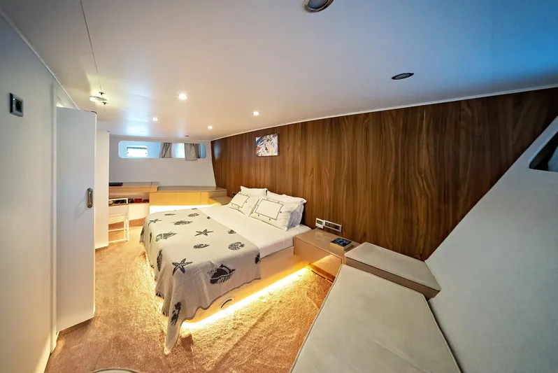  Yacht Photos Pics Luxurious 2023 custom motorsailer bedroom with modern design and ambient lighting.