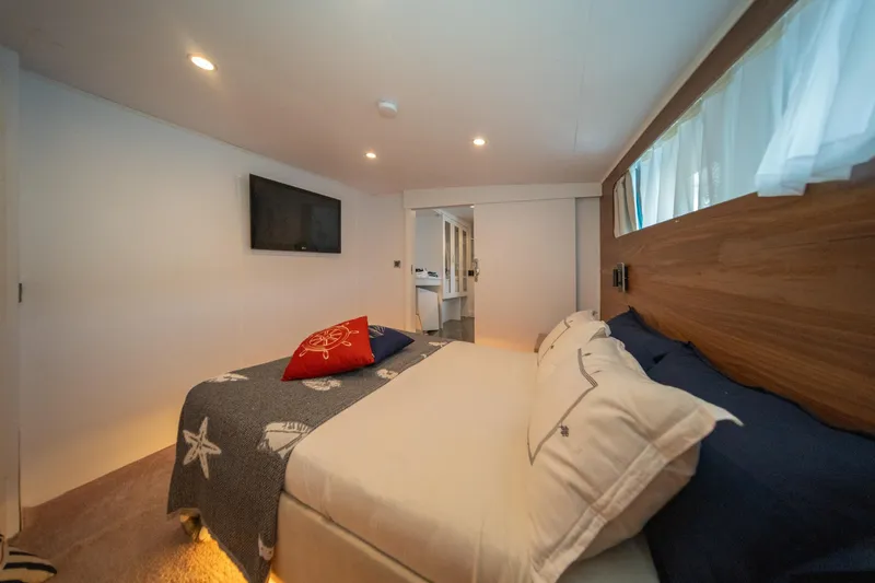  Yacht Photos Pics Luxurious bedroom in 2023 Custom Made Motorsailer with modern decor and cozy bedding.