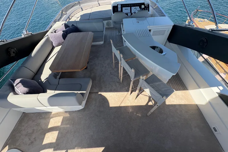  Yacht Photos Pics Luxurious 2018 Sunseeker 86 Yacht flybridge with seating, bar, and ocean view.
