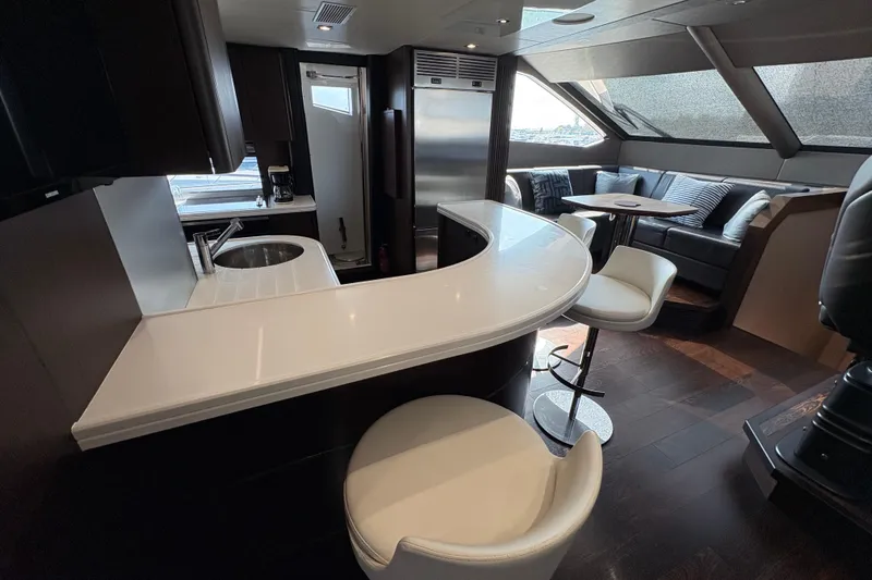  Yacht Photos Pics Luxurious interior of 2018 Sunseeker 86 Yacht with modern bar and seating area.