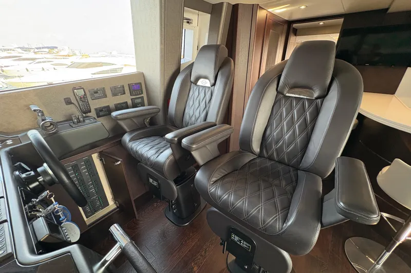  Yacht Photos Pics Luxurious cockpit seating in a 2018 Sunseeker 86 Yacht, featuring plush leather chairs.