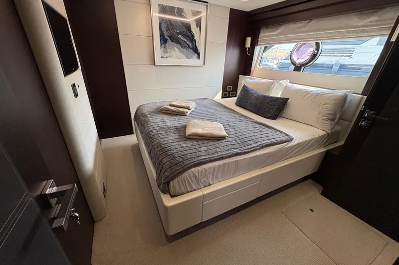  Yacht Photos Pics Luxurious bedroom interior of 2018 Sunseeker 86 Yacht with modern decor and window view.
