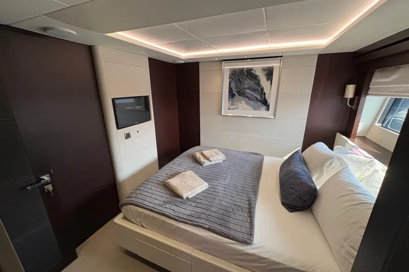 Yacht Photos Pics Luxurious bedroom interior of 2018 Sunseeker 86 Yacht with modern decor and cozy bedding.