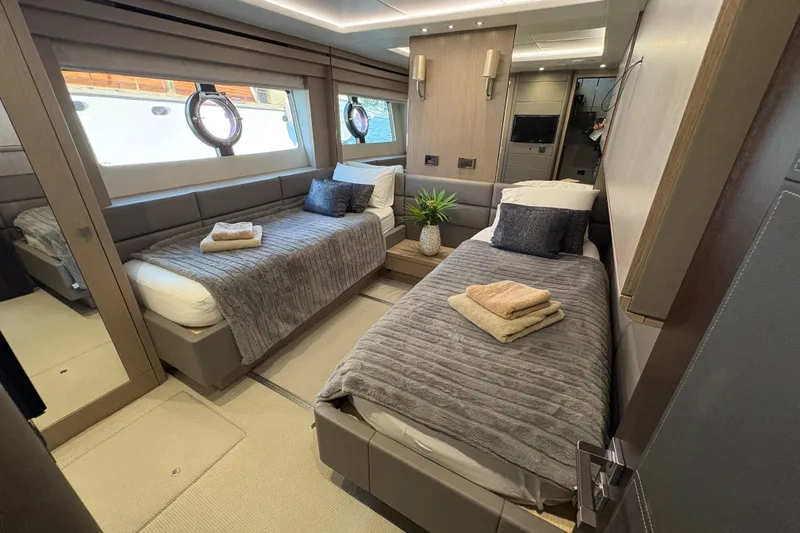  Yacht Photos Pics Luxurious twin bedroom on 2018 Sunseeker 86 Yacht, featuring modern decor and cozy bedding.