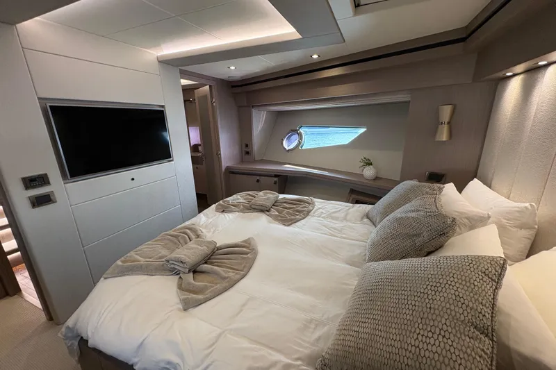  Yacht Photos Pics Luxurious bedroom interior of 2018 Sunseeker 86 Yacht with modern decor and window view.