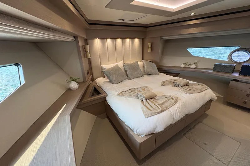  Yacht Photos Pics Luxurious bedroom interior of 2018 Sunseeker 86 Yacht with elegant decor and ocean view.