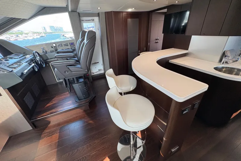  Yacht Photos Pics Luxurious interior of 2018 Sunseeker 86 Yacht with helm and bar area.