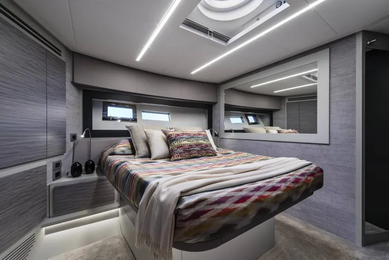  Yacht Photos Pics Luxurious bedroom interior of 2023 Pershing 6X yacht with modern design and ambient lighting.
