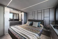 Luxurious bedroom interior of 2023 Pershing 6X yacht with modern design and elegant decor.