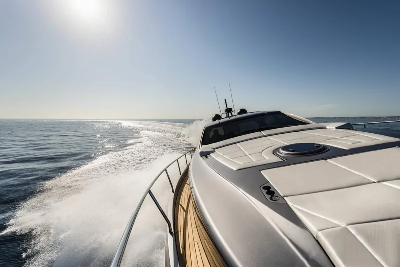  Yacht Photos Pics 2023 Pershing 6X yacht cruising on open sea under clear sky.