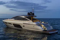 2023 Pershing 6X yacht cruising on calm ocean waters at dusk.