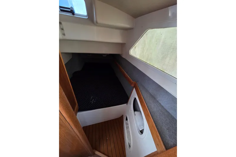 Prosecco Yacht Photos Pics Interior cabin of 1997 Seawind 1000 catamaran with wooden flooring and side window.