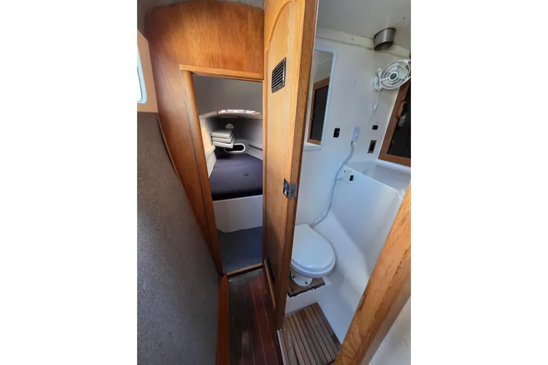 Prosecco Yacht Photos Pics Interior of 1997 Seawind 1000 catamaran showing cabin and compact bathroom.