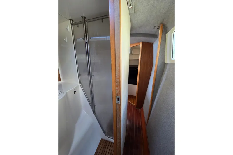 Prosecco Yacht Photos Pics Interior of 1997 Seawind 1000 catamaran, featuring a compact bathroom and wooden flooring.