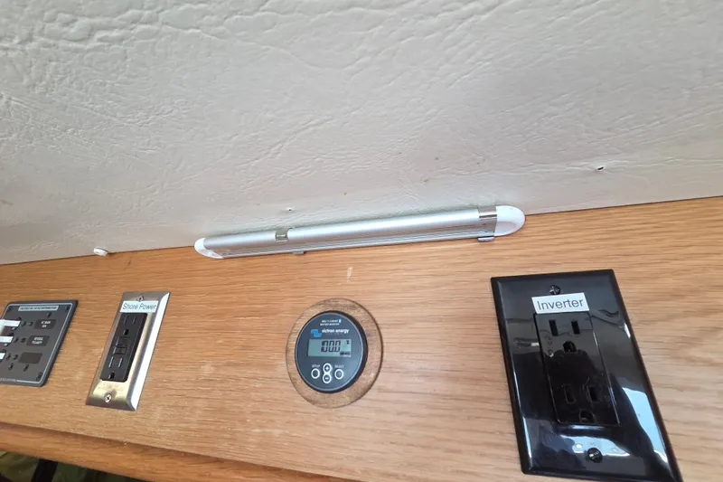 Prosecco Yacht Photos Pics Control panel of a 1997 Seawind 1000 catamaran with shore power and inverter outlets.