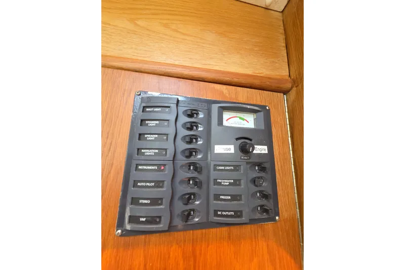 Prosecco Yacht Photos Pics Electrical panel on a 1997 Seawind 1000 catamaran, featuring various switches and a voltmeter.