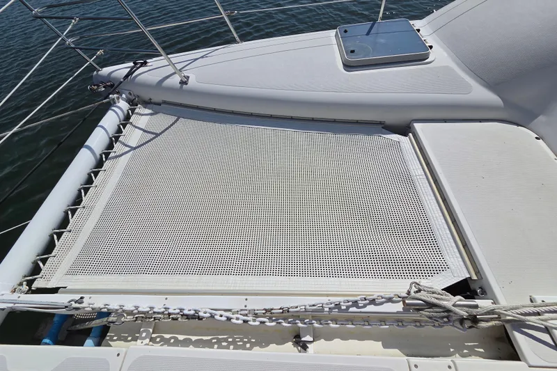 Prosecco Yacht Photos Pics 1997 Seawind 1000 catamaran deck with netting over water.