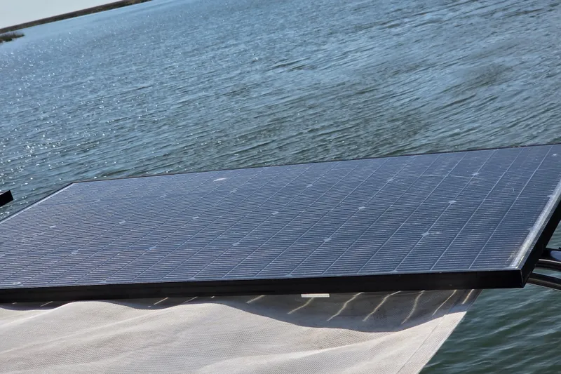 Prosecco Yacht Photos Pics Solar panel on a 1997 Seawind 1000 catamaran, positioned over water.
