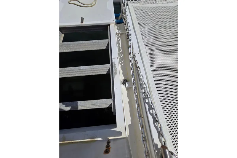 Prosecco Yacht Photos Pics Deck view of 1997 Seawind 1000 catamaran, featuring netting and chain details.