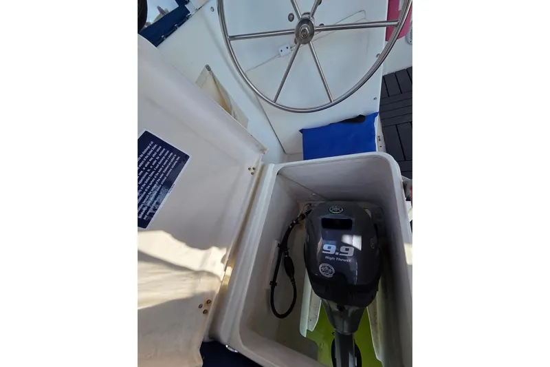 Prosecco Yacht Photos Pics Steering wheel and 9.9 high thrust engine on 1997 Seawind 1000 catamaran.