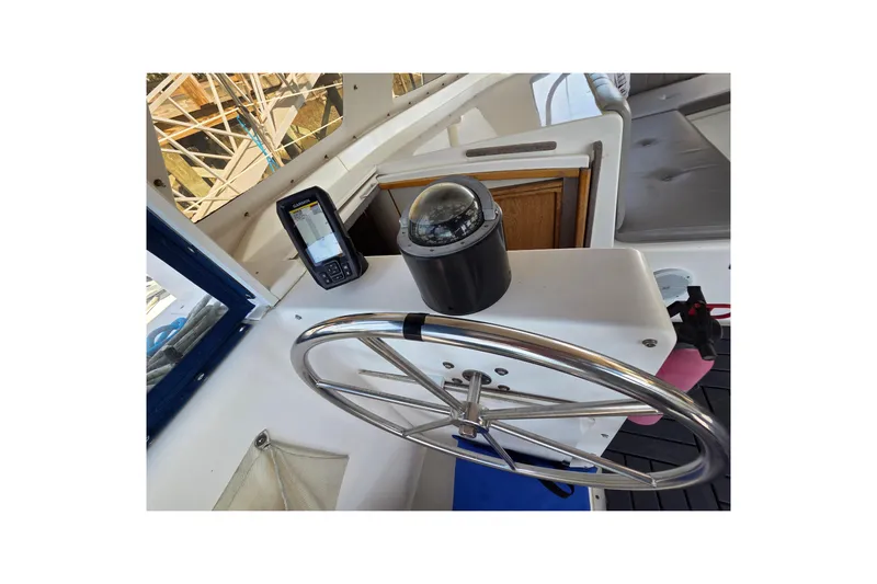 Prosecco Yacht Photos Pics Steering wheel and navigation equipment on a 1997 Seawind 1000 catamaran.