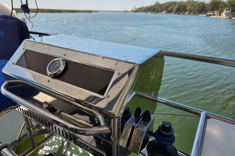 Prosecco Yacht Photos Pics Seawind 1000 yacht with a stainless steel grill, cruising on a serene waterway.