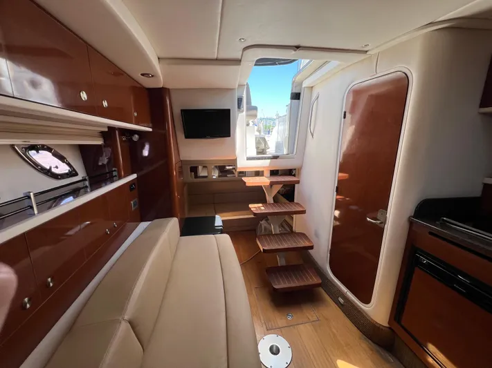 Freedom Of The Seize Yacht Photos Pics Interior of 2014 Sea Ray 330 Sundancer yacht with modern amenities and wooden finishes.