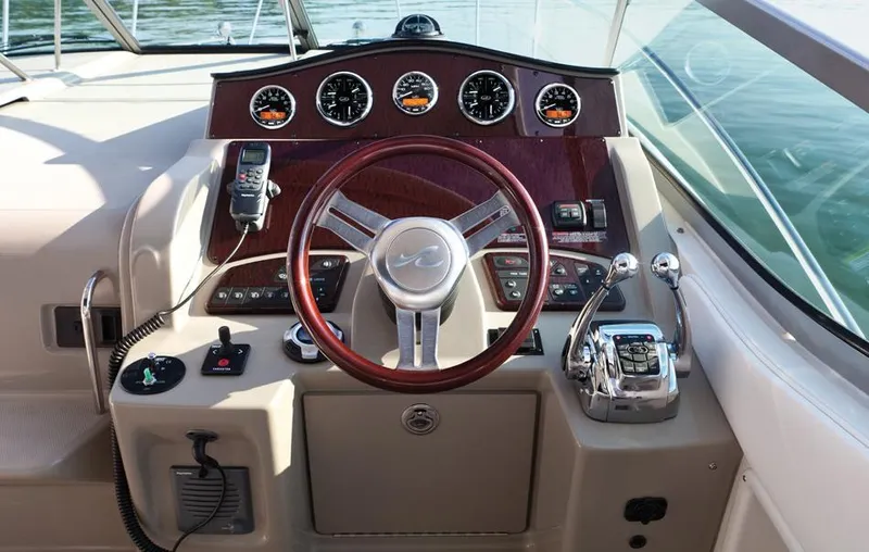 Freedom Of The Seize Yacht Photos Pics 2014 Sea Ray 330 Sundancer helm with steering wheel and control panel.