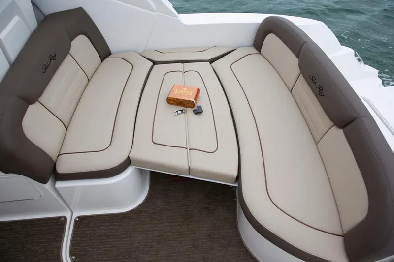 Freedom Of The Seize Yacht Photos Pics 2014 Sea Ray 330 Sundancer boat seating area with beige and brown cushions.