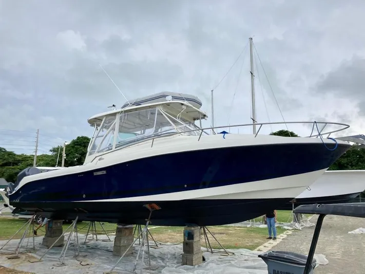  Yacht Photos Pics 2006 Hydra-Sports 3300 VX boat on stands, blue and white hull, outdoor setting.