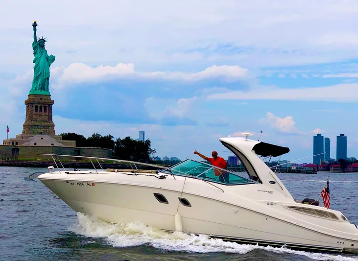 Freedom Of The Seize Yacht Photos Pics 2014 Sea Ray 330 Sundancer cruising near the Statue of Liberty.