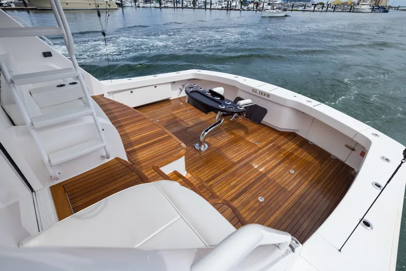 "el Jefe" Yacht Photos Pics Luxurious 2014 Viking 70 Convertible yacht with teak deck and fishing chair on open water.