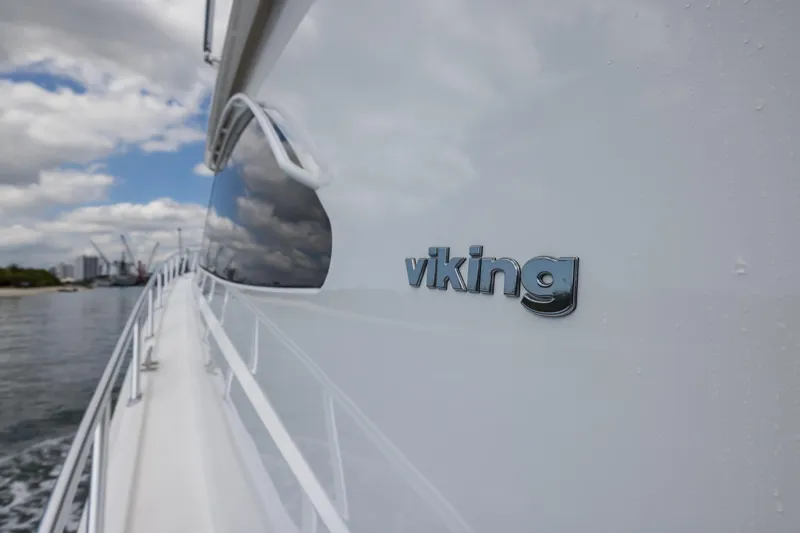 "el Jefe" Yacht Photos Pics 2014 Viking 70 Convertible yacht cruising on a sunny day, showcasing sleek design and branding.