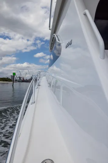 "el Jefe" Yacht Photos Pics 2014 Viking 70 Convertible yacht cruising on a cloudy day, showcasing sleek design and craftsmanship.