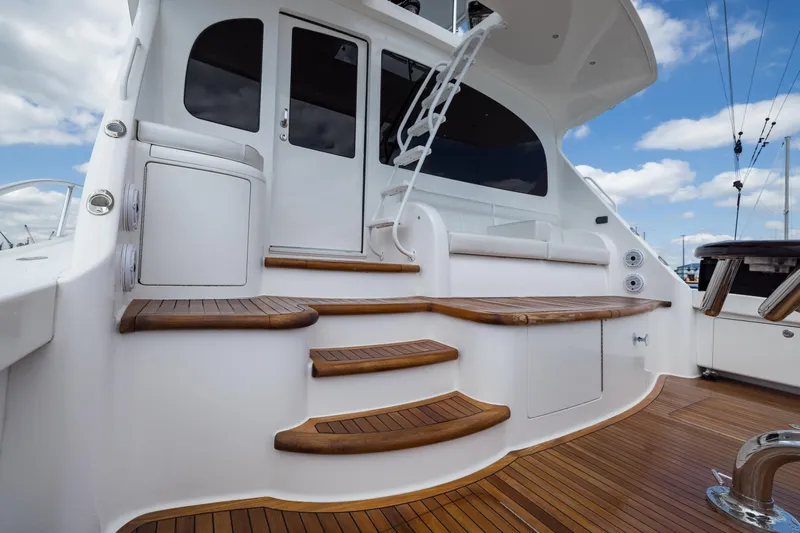 "el Jefe" Yacht Photos Pics 2014 Viking 70 Convertible yacht with elegant wooden steps and sleek white exterior.
