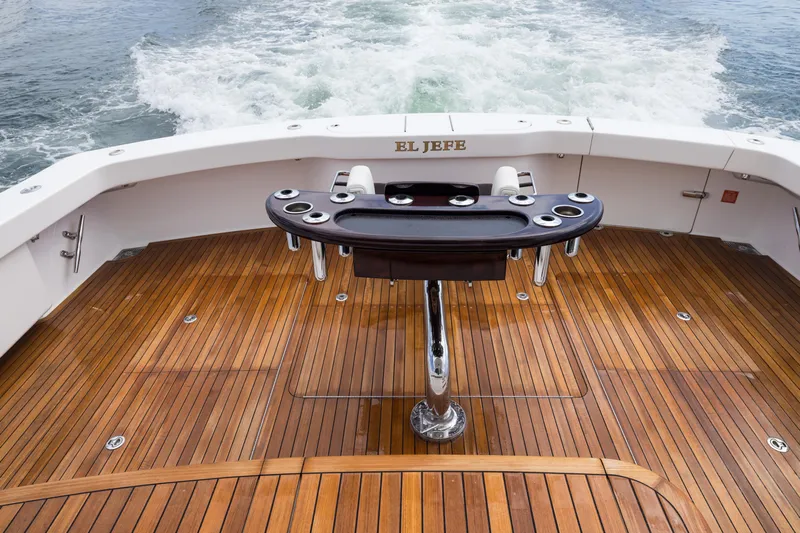 "el Jefe" Yacht Photos Pics 2014 Viking 70 Convertible yacht deck with fishing station, named "El Jefe," on open water.