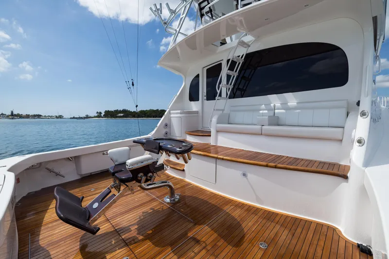 "el Jefe" Yacht Photos Pics 2014 Viking 70 Convertible yacht deck with fishing chair, wooden flooring, and ocean view.
