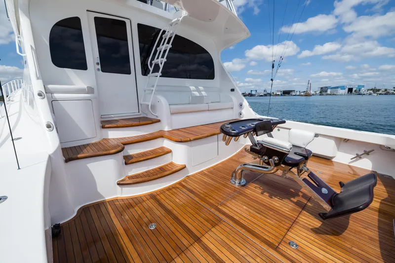 "el Jefe" Yacht Photos Pics Luxurious 2014 Viking 70 Convertible yacht with teak deck and fishing chair, docked by the sea.