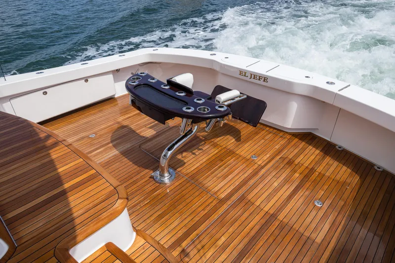 "el Jefe" Yacht Photos Pics 2014 Viking 70 Convertible yacht deck with fishing chair, teak flooring, and ocean view.