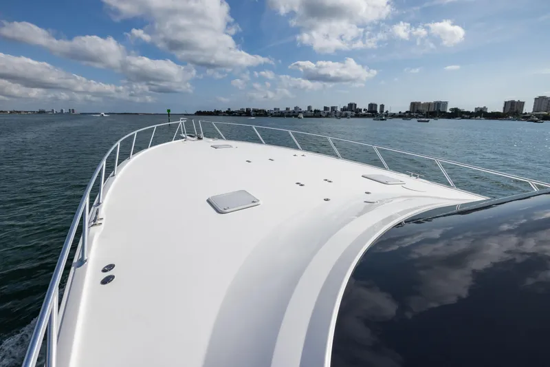 "el Jefe" Yacht Photos Pics 2014 Viking 70 Convertible yacht cruising on a sunny day with city skyline in background.